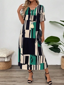 Detail of V-neck printed dress showing geometric color block pattern in vintage green