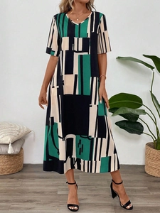 Detail view of V-neckline and geometric print on a summer midi dress with short sleeves