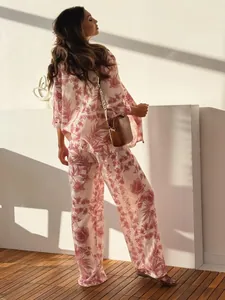 Detail view of floral loungewear set showing wide-leg pants and silky fabric texture