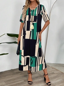 Detail view of the V-neckline and modern geometric color block print on the dress
