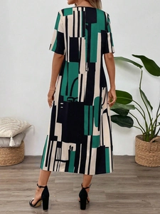 Rear view of women's summer midi dress featuring geometric color block print in green and black