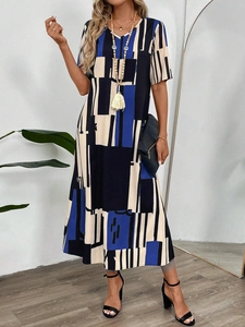 Detail of V-neck loose dress featuring dark blue and beige geometric abstract patterns