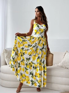 Detailed view of summer floral dress featuring bright lemon print and pleated hem layers