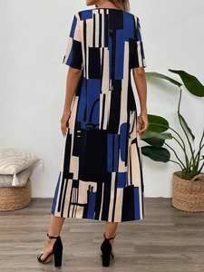 Rear view of long V-neck floral dress with blue and black geometric abstract print