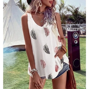 Close-up of white V-neck tank top with colorful feather prints and lace shoulder straps