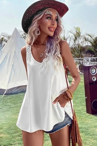 Detailed view of bohemian white V-neck lace tank top styled for outdoor festivals