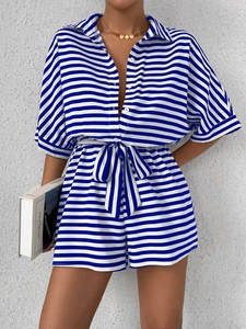 Detail of blue and white striped romper with button-down collar and belted waistline