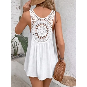 Detail of white bohemian tank top featuring an intricate crochet hollow-out back design