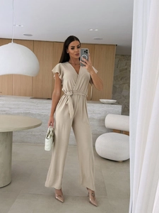 Detail view of beige v-neck jumpsuit with ruffle sleeves and waist tie belt