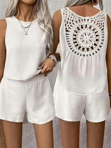 Detail of white two-piece summer set with crochet cutout back and linen texture