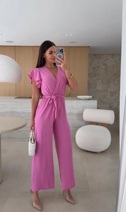 Close-up of V-neck jumpsuit with ruffled sleeves and adjustable waist tie in dark pink