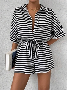 Detail of black and white striped romper with turn-down collar and waist belt tie