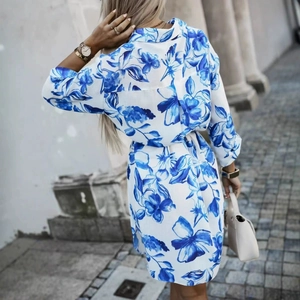Elegant white floral maxi dress with blue print and waist tie shown from the back view