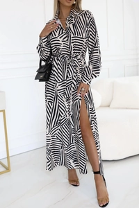 Detail of long sleeve wrap dress featuring black and white abstract print and side slit