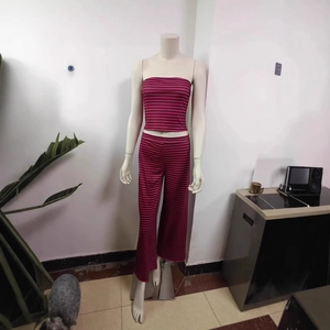 Detail of fuchsia and black striped tube top and wide-leg trousers set on a mannequin