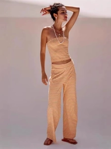 Two-piece orange and white striped set with bandeau top and high-waist wide-leg pants