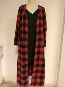 Detail view of the red and black buffalo plaid pattern on a long-sleeved open cardigan