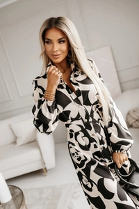 Detail of shirt dress with black and white floral print, lapel collar and waist belt