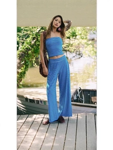 Outdoor shot of blue striped tube top and wide-leg pants set by a scenic lake