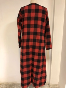 Detail of red and black buffalo plaid long-sleeve cardigan with soft flannel texture