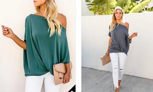 Detail of off-shoulder batwing sleeve tunic in dark green and grey soft fabric