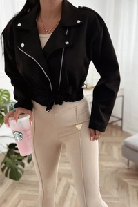 Close-up of black faux suede biker jacket with silver zippers and belt detailing