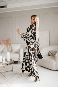 Detail of elegant black and white rose floral print on a long sleeve satin dress