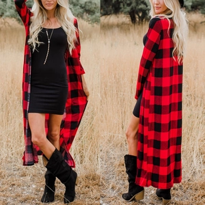 Detail view of long red and black buffalo plaid cardigan with long sleeves in outdoors