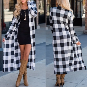Detail view of women's long black and white plaid cardigan with casual autumn fit