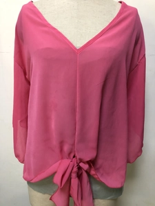 Detailed view of the V-neck cut and front tie-knot on the rose pink chiffon blouse