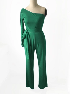Detailed view of the emerald green one-shoulder jumpsuit featuring a sleek tie waist