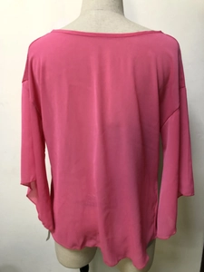 Rear view of vibrant fuchsia chiffon blouse with elegant boat neck and loose draping sleeves