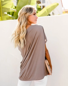 Outdoor shot of loose-fitting brown women's t-shirt with soft draping fabric and casual style