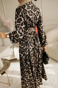 Detailed macro view of leopard print satin dress with lantern sleeves and waist belt