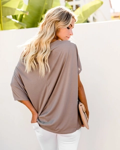 Detail view of mocha off-shoulder t-shirt showing back seam and draped fabric texture