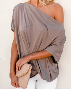 Detail of taupe off-shoulder t-shirt showing draped pleats and lightweight fabric texture