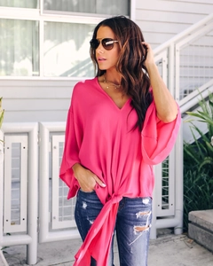 Detail of rose pink V-neck chiffon blouse featuring flutter sleeves and a front tie knot