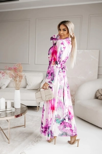 Detailed view of women's long floral dress featuring pink patterns and a back bow detail