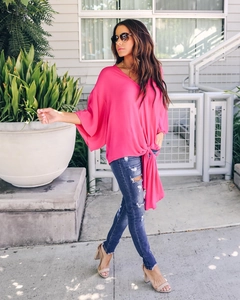 Detail of rose pink V-neck chiffon blouse with batwing sleeves and hem tie-knot design