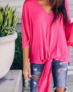 Detail of rose pink V-neck chiffon top featuring butterfly sleeves and front knot tie