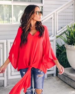 Close-up of red V-neck chiffon blouse featuring stylish front tie tassel and split sleeves