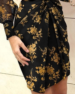 Detail of ruched side seams and golden floral print on a black mesh sleeve midi dress