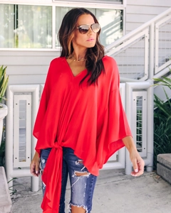Detail of red V-neck chiffon blouse with tie-front knot and ruffled flutter sleeves