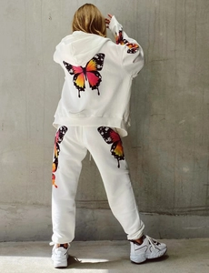 Rear view of white hoodie tracksuit set featuring vibrant colorful butterfly print details