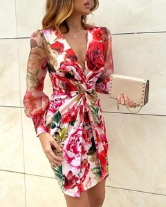 Detailed view of deep V-neckline and knotted waist on floral print midi dress