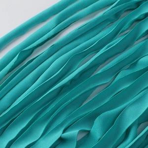Detail of high-density turquoise woven ribbon showing fine twill texture and flat edges