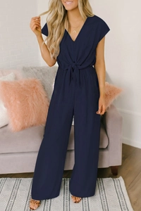 Detail of navy blue V-neck jumpsuit with waist bow tie and wide-leg trousers design