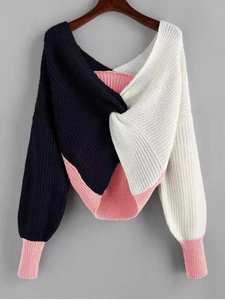 Close-up of contrast color knit sweater with twisted neckline and navy white pink details