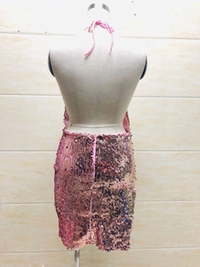 Detail of pink sequin backless dress showing halter neck design and metallic finish