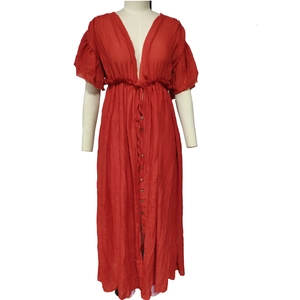 Detail of red V-neck maxi dress featuring ruffled sleeves and a button-down front bodice